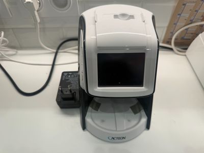 a white and black camera sitting on top of a counter