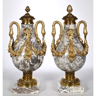 pair of antique marble urns with gilded handles on marble bases
