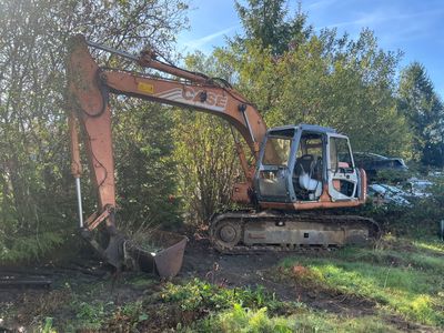 a small excavator that is sitting in the grass
