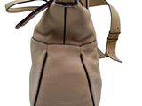 the back view of a beige purse with a strap on it