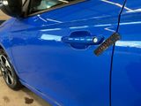 a blue car with a remote control on the side of it