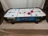 the air hockey table is ready to be played in the game room