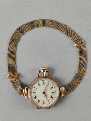 an image of a gold watch with a chain around it