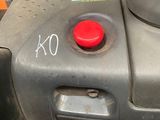 a close up of a machine with a red button on it