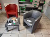 two chairs and a coffee table in a small room