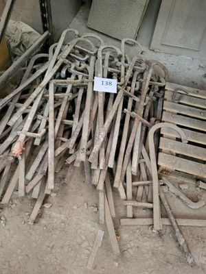 a pile of old wooden chairs and a sign on the floor