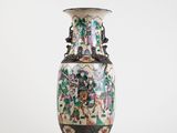 a vase with a floral design on it sitting on a table