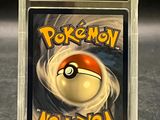 the card is in a clear plastic case with a pokemon logo on it