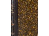 an old book with a black cover and gold speckles on it
