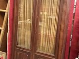 a large wooden cabinet in the middle of a room