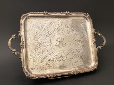 an ornate silver tray with handles and handles on a black background