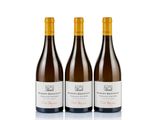three bottles of wine sitting on top of a white surface