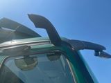a close up of a green truck with its door open