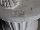 a statue of a woman on a pedestal with a plaque on it