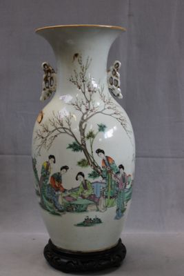 a white vase with a painting on it sitting on a table