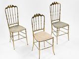 three chairs with a cushion on the back of them against a white background