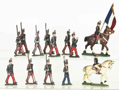 many figurines of soldiers on display on a white surface