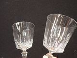 two wine glasses sitting on a table next to each other
