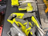 two corded circular saws and two circular circular saws on a workbench