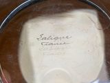 a silver plate with writing on it sitting on a table
