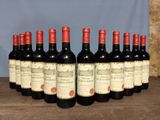 six bottles of red wine are lined up on a wooden table