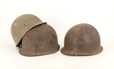 two helmets are sitting next to each other on a white surface