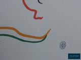 a drawing of a woman ' s face on a white wall