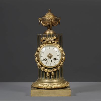 an image of a gold clock sitting on top of a table