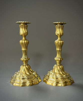 paire de chandeliers anciens en laiton sur fond gris