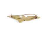 an image of a gold brooch with a leaf on it