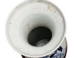 a blue and white vase sitting on top of a table