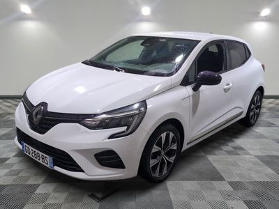 a white car is parked on a checkered floor in a garage