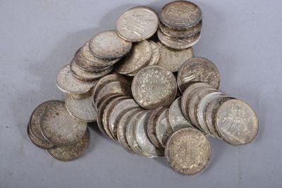 a pile of silver coins sitting on a table