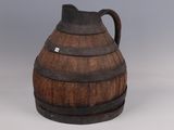 an old wooden barrel shaped jug with a handle on a gray background