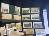 a lot of old photos on display on a table