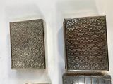 three metal objects on a white wall next to each other