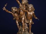 a bronze statue of three chers on a pedestal with a bird in the air
