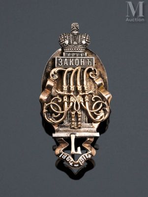 a close up of a metal badge with a crown on it