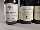 three bottles of wine sitting on top of a table next to each other