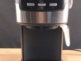 a coffee maker that is sitting on a wooden table