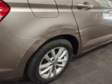 a car that is parked in a garage with its door open