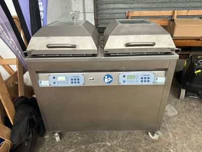 two large stainless steel ovens sitting next to each other