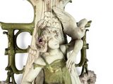 a statue of a woman holding a bird in her hand