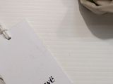 a white tag that says swedewe on it next to a pair of shoes