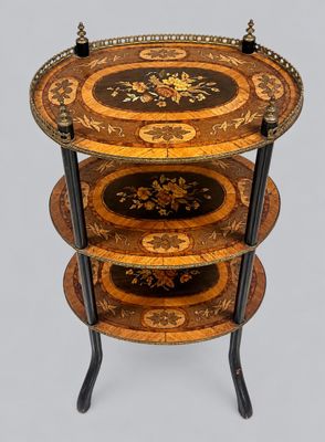a three tiered table with a decorative design on it