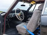 a black car with a blue seat belt in the back of it