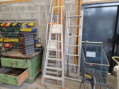 a ladder that is leaning against a wall next to other items