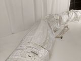 a large piece of paper wrapped in plastic on top of a bed