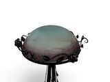 a bird bath sitting on top of a metal stand