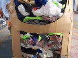 a cardboard cart full of clothes in a warehouse